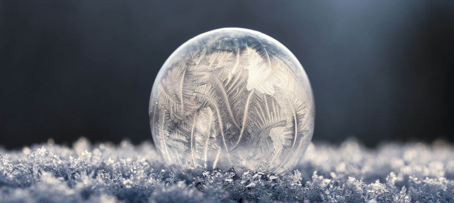 frozen bubble sitting atop snow