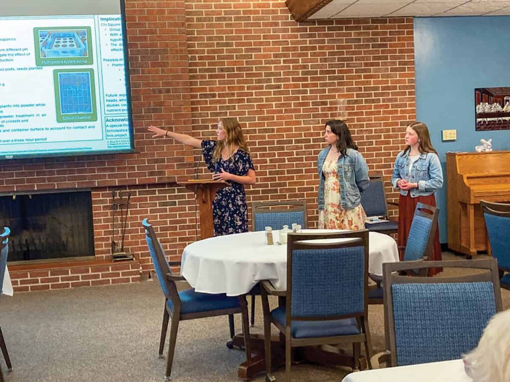 Benedictine College students present their project findings to the sisters.