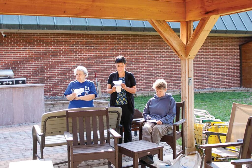 Sisters Patricia Gamgort, Elizabeth Carrillo, and Barbara Smith pray before they work.