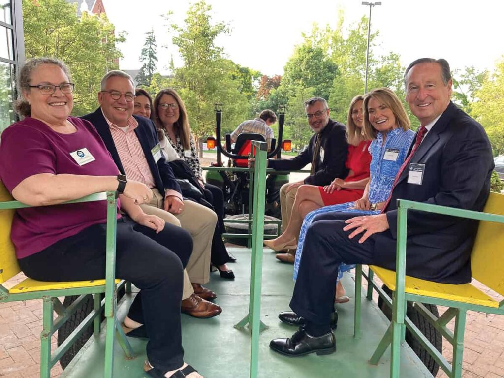 Sister Suzanne Fitzmaurice (front left) and Sister Elaine Fischer (driving) take the BC Board and Cabinet members (including President Stephen Minnis and his wife Amy, front right) on a tour of the Mount grounds.