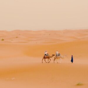 3 people traveling in the desert