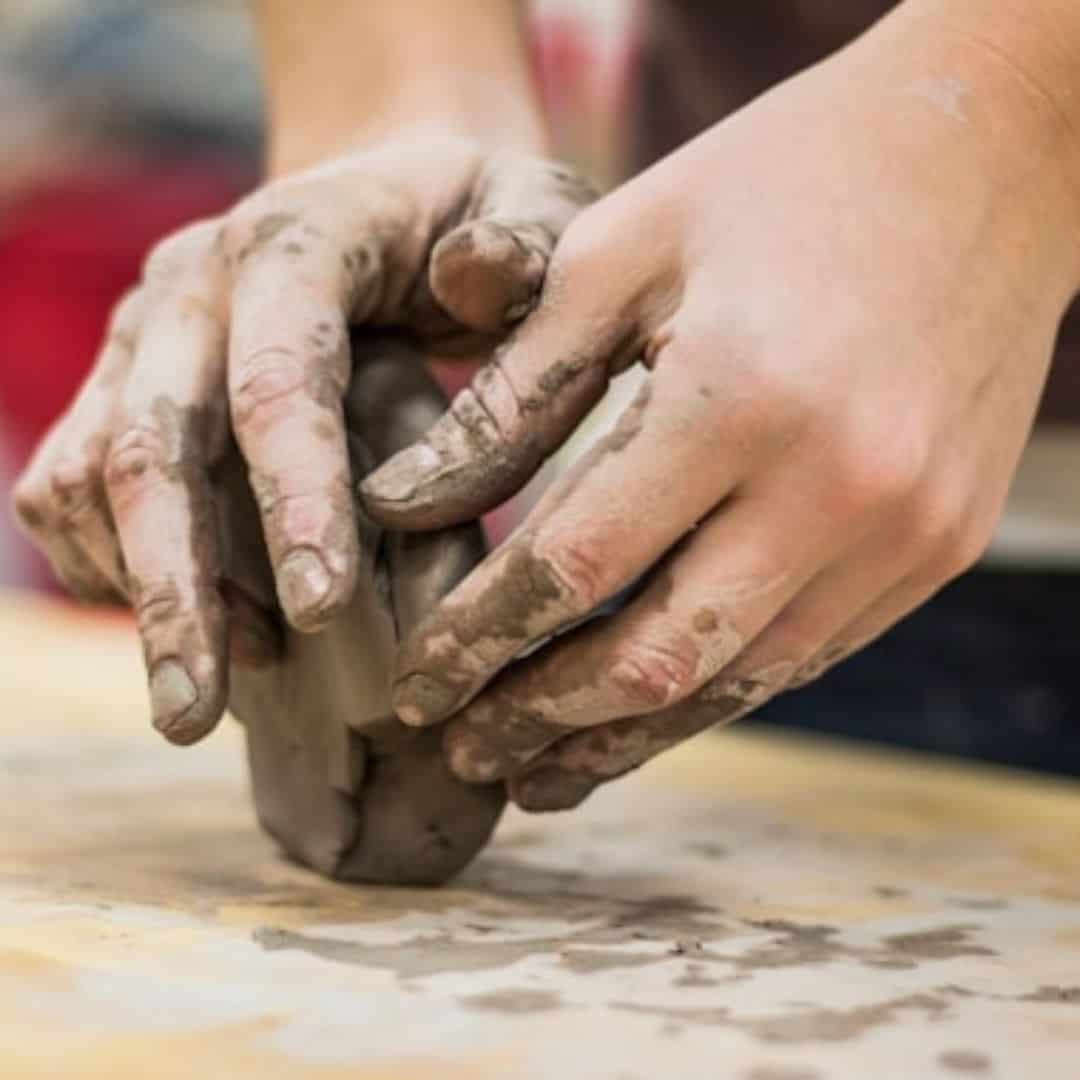 hands shaping clay