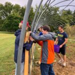 Students learning about and building the hoop house.