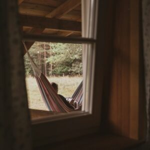 view from inside, looking out at person in hammock relaxing