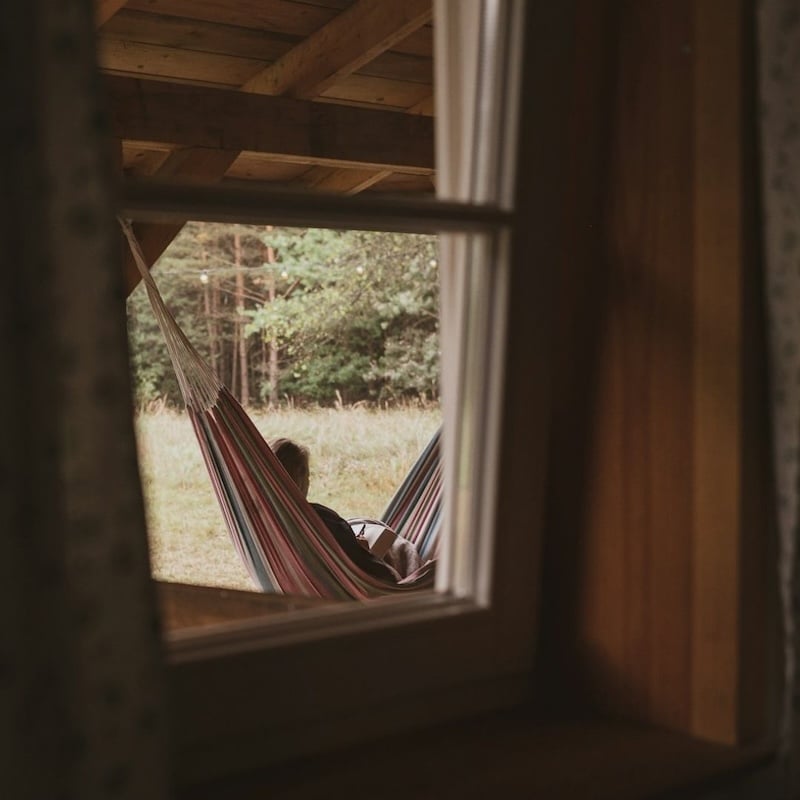 view from inside, looking out at person in hammock relaxing
