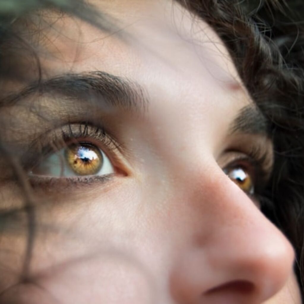 close up of woman's eyes wide open and looking up