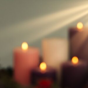blurred advent candles with a ray of light shining on them
