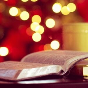 open Bible with soft Christmas lights in the background