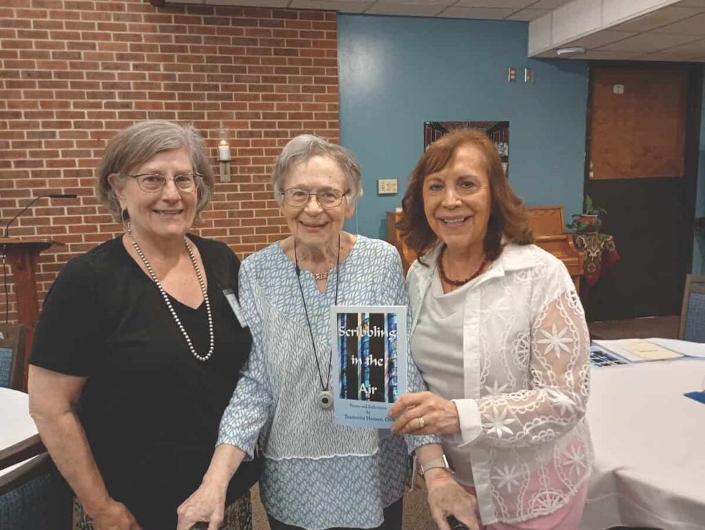 Oblates presented Sister Thomasita Homan with a book of her poems, Scribbling in the Air, to thank her for her years of service as an oblate director at the Mount. L-R: Oblate Director Faye Miller, Sister Thomasita, and Oblate Judith Valente.